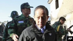 South Korean Defense Minister Kim Tae-young, who has resigned, looks at the destroyed houses on Yeonpyeong Island, South Korea, Nov. 25, 2010.