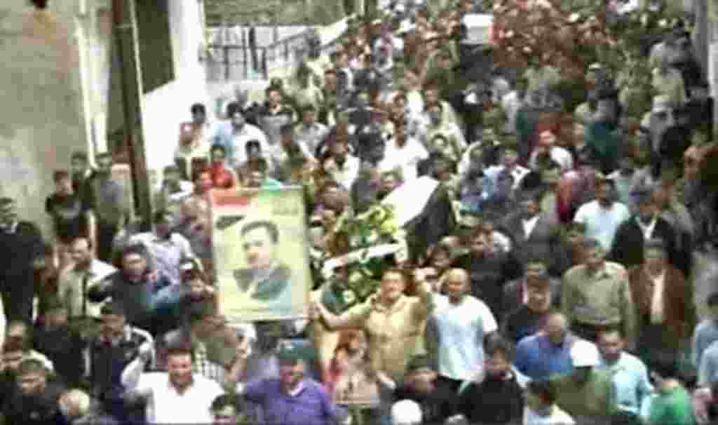 Syrian Arab News Agency (SANA) handout photo shows people gathering for funeral of two people allegedly killed in recent clashes in Homs, 160 kilometers (100 miles) to the north of Damascus on April 19, 2011.