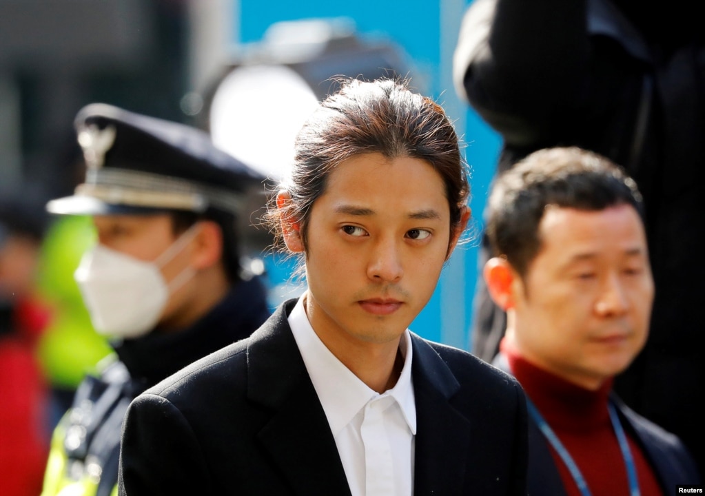 South Korean singer Jung Joon-young arrives for questioning on accusations of illegally filming and sharing sex videos on social media, at the Seoul Metropolitan Police Agency in Seoul.