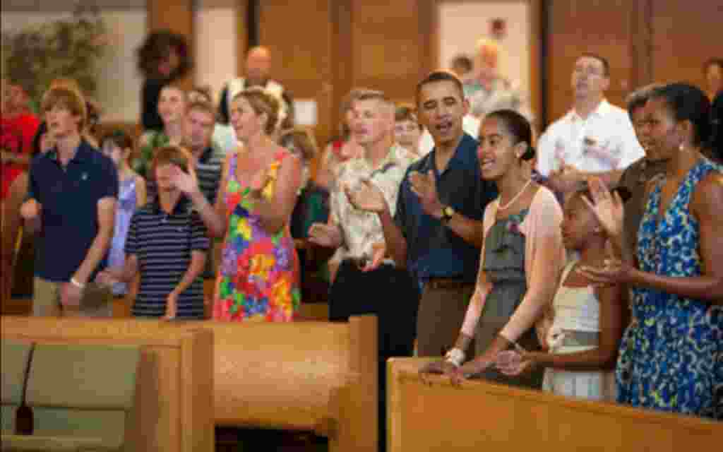 Obama and Michelle Obama, daughters, sing during services at St. Michael's Chapel at Marine Corps Base Hawaii