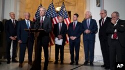 Republican Senator Rob Portman, center, standing with with other senators, speaks during a news conference on Capitol Hill in Washington, Jan. 19, 2022.