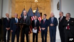 Republican Senator Rob Portman, center, standing with with other senators, speaks during a news conference on Capitol Hill in Washington, Jan. 19, 2022.
