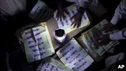 FILE - Election workers count votes at a station that reported a high voter turnout in Kidal, Mali Sunday, July 28, 2013. 