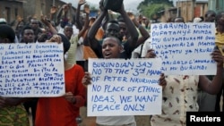 FILE - Protesters march who are against Burundi President Pierre Nkurunziza and his bid for a third term, in Bujumbura, Burundi, June 4, 2015.