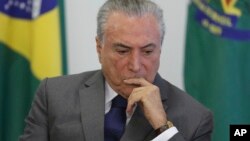 Brazil's President Michel Temer attends a ceremony at the Planalto presidential palace, in Brasilia, Brazil, April 12, 2017. Brazil's Supreme Court announced corruption investigations into eight ministers and dozens more top politicians in a sweeping decision that affects almost one third of embattled President Michel Temer's Cabinet and many of his top allies.