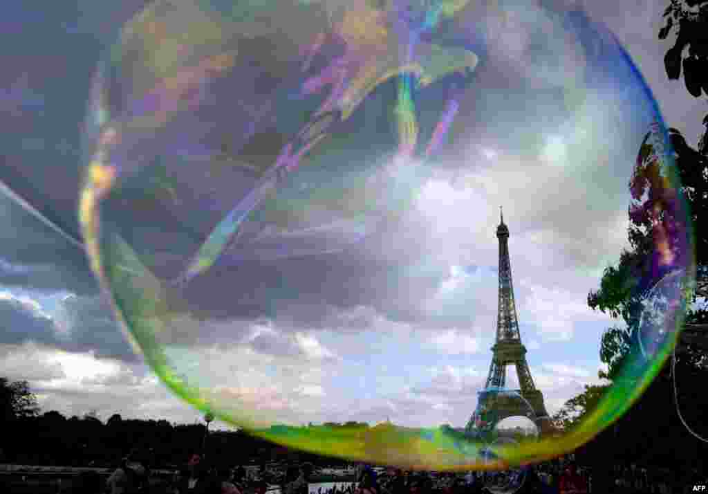 The Eiffel Tower is seen through bubbles being blown in Paris, France. 