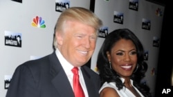 FILE - Donald Trump and Omarosa Manigault are seen at "The All-Star Celebrity Apprentice Event."