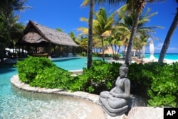 FILE - A statue decorates the pool area of Richard Branson's property on Necker Island in the British Virgin Islands.