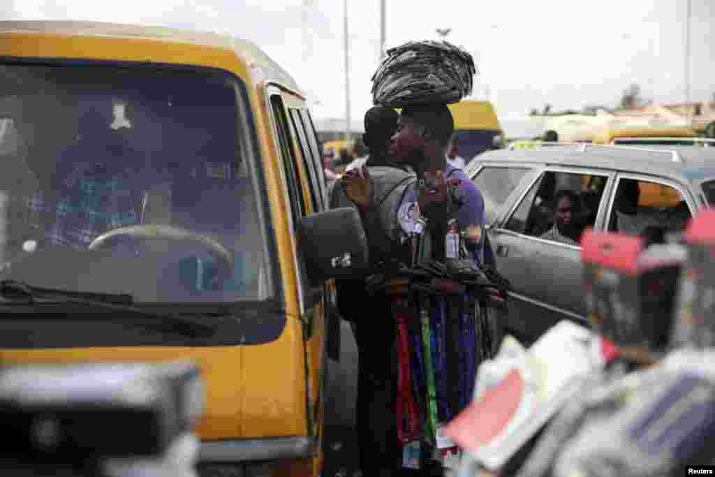 A man hawks his goods at a motor park in the Obalende district of Lagos.