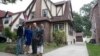 In this Sept. 16, 2017, photo, Abdi Iftin, left, of Somalia, Uyen Nguyen, second from left, of Vietnam, Eiman Ali, right, of Somalia born in Yemen, and Ghassan al-Chahada, of Syria pose outside President Donald Trump's boyhood home in the Queens borough of New York. 