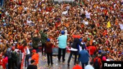 Venezuela's President Nicolas Maduro greets supporters next to his wife Cilia Flores during a campaign rally in San Felipe, Venezuela, May 9, 2018. 