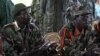 FILE - The leader of the Lord's Resistance Army, Joseph Kony, left, and his deputy, Vincent Otti, are seen sitting inside a tent in Ri-Kwamba, southern Sudan, Nov. 12, 2006.