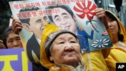 FILE - Former comfort woman Kil Un-ock, forced into sexual slavery to Japanese troops during World War II, attends a rally protesting a U.S. visit by Japanese Prime Minster Shinzo Abe, outside the Japanese Embassy in Seoul.