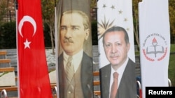 FILE - Banners with pictures of modern Turkey's founder Ataturk and Turkish President Tayyip Erdogan are pictured during the opening ceremony of Recep Tayyip Erdogan Imam Hatip School in Istanbul, Turkey, Sep. 29, 2017. 