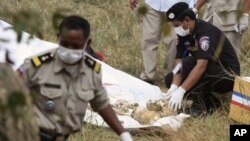 Police officials collect skulls and bones thought to be of Laurent Valier and his children in Kampong Speu province January 15, 2012, file photo. 