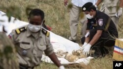 Police officials collect skulls and bones thought to be of Laurent Vallier and his children in Kompong Speu province January 15, 2012. 