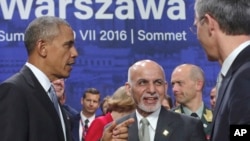 Afghan President Ashraf Ghani, center, speaks with U.S. President Barack Obama and NATO Secretary General Jens Stoltenberg at the NATO summit in Warsaw, Poland, July 9, 2016.