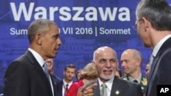 Afghan President Ashraf Ghani, center, speaks with U.S. President Barack Obama and NATO Secretary General Jens Stoltenberg at the NATO summit in Warsaw, Poland, July 9, 2016.