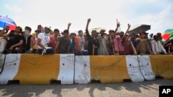 Supporters of anti-government cleric Tahir-ul-Qadri block an entrance of the parliament during a protest at Islamabad's high-security Red Zone in Islamabad, Pakistan, Aug. 20, 2014.