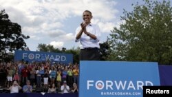 U.S. President Barack Obama reacts to supporters during a campaign event in Rochester, New Hampshire, August 18, 2012.