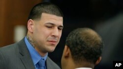 Former New England Patriots tight end Aaron Hernandez cries as he turns to defense attorney Ronald Sullivan reacting to his double murder acquittal at Suffolk Superior Court, April 14, 2017 in Boston. 