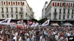 Workers take part in a rally during a protest by the PAME Communist-affiliated union in central Athens, July 20, 2011