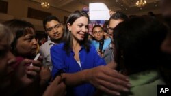 Venezuelan opposition politician Maria Corina Machado, shown greeting supporters after a news conference in Caracas on July 15, 2015, says she's been barred from holding public office ahead of December's congressional election. 