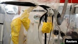 FILE - A health worker wearing Ebola protection gear enters the Biosecure Emergency Care Unit (CUBE) at the ALIMA (The Alliance for International Medical Action) Ebola treatment centre in Beni, in the Democratic Republic of Congo, April 1, 2019. (REUTERS/Baz Ratner)