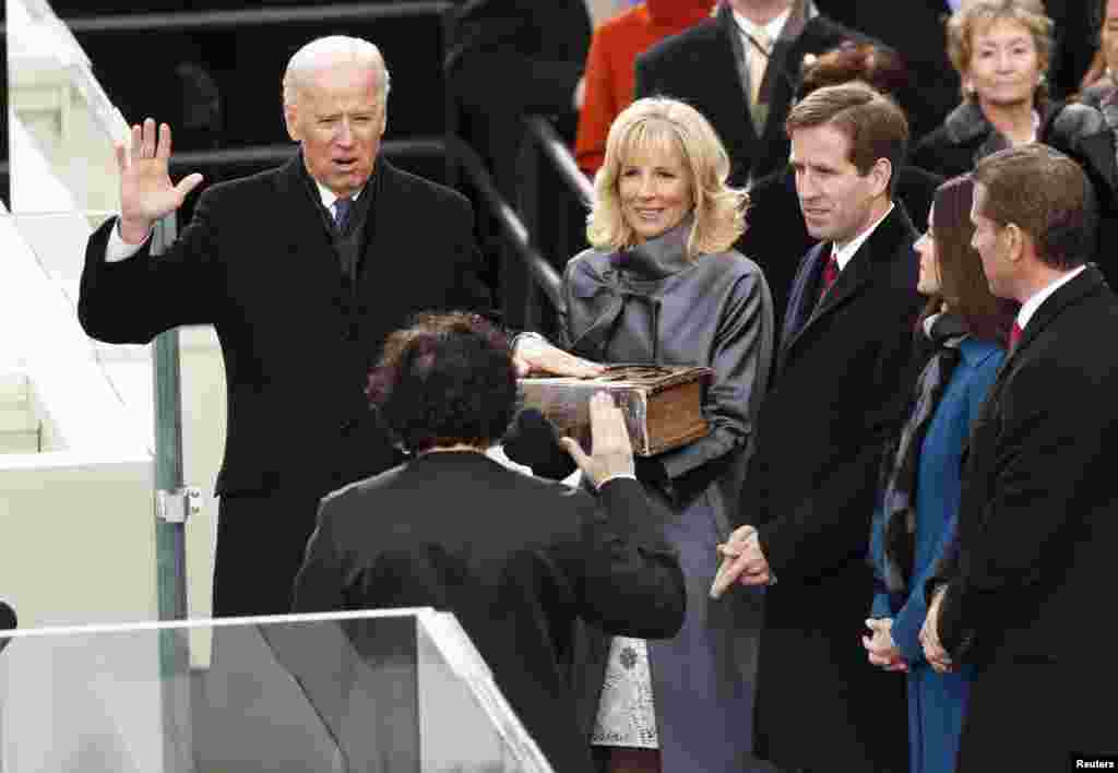 Vice President Joe Biden (L) takes the oath from Supreme Court of the US Justice Sonya Sotomayor (2nd L) as Biden's wife Dr. Jill Biden holds the bible during swearing-in ceremonies on the West front of the U.S Capitol in Washington, January 21, 2013