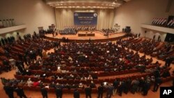 FILE - In this Sept. 8, 2014 file photo, Iraqi lawmakers attend a session in Baghdad, Iraq. 