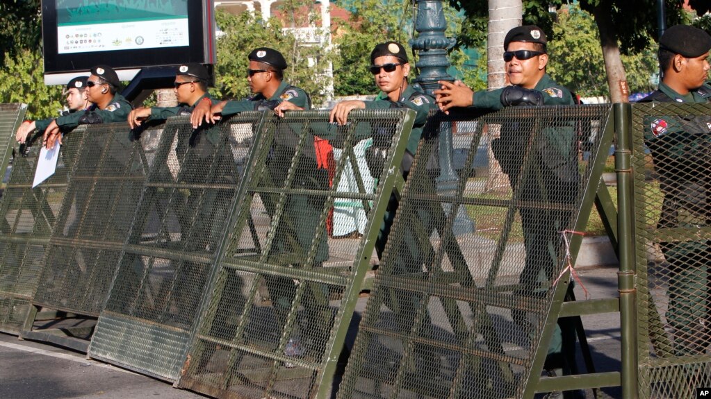 Riot police stand guard at a blocked street outside the Supreme Court in Phnom Penh, Cambodia, Nov. 16, 2017.