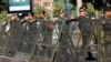 Riot police stand guard at a blocked street outside the Supreme Court in Phnom Penh, Cambodia, Nov. 16, 2017.