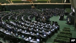 FILE - This photo taken on Feb. 19, 2017 shows an open session of the Iranian parliament in Tehran. Iran's parliament voted overwhelmingly Sunday to increase spending on its ballistic missile program and the foreign operations of Revolutionary Guard.