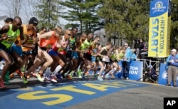 FILE - Elite men runners leave the start line in the 118th running of the Boston Marathon April 21, 2014. Fourth from left is eventual winner Meb Keflizighi