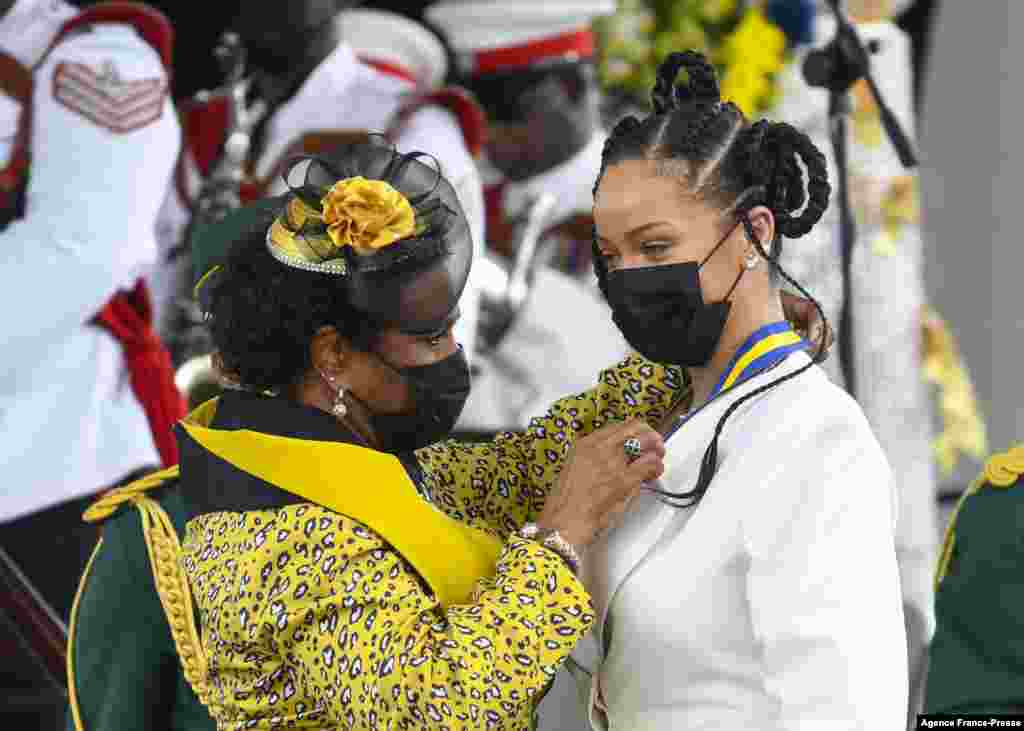 Rihanna Fenty (R) being conferred with the honour of Barbados 11th National Hero by President Dame Sandra Mason (L) during the National Honors ceremony and Independence Day Parade at Golden Square Freedom Park in Bridgetown, Nov. 30, 2021