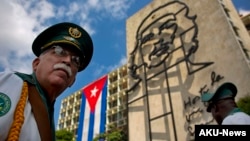 FILE - Members of a military band stand under the iron sculpture of Ernesto "Che" Guevara at Revolution Square in Havana, Cuba