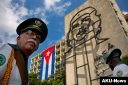 FILE - Members of a military band stand under the iron sculpture of Ernesto "Che" Guevara at Revolution Square in Havana, Cuba