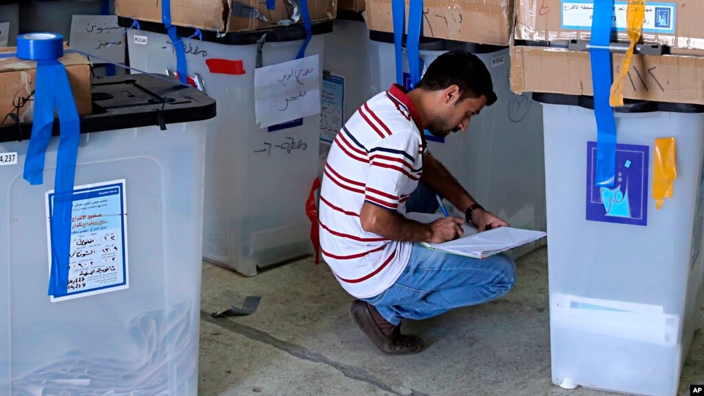 FILE - An electoral worker checks ballot boxes at the Independent High Electoral Commission center in Baghdad, Iraq, May 17, 2018.