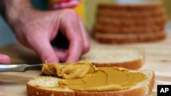 This sandwich is being made with soy peanut butter.