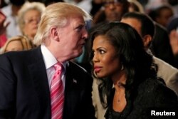 FILE - Republican presidential nominee Donald Trump and Omarosa Manigault attend a church service in Detroit, Michigan, Sept. 3 2016.