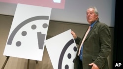 Climate scientist Richard Somerville, a member, Science and Security Board, Bulletin of the Atomic Scientists, unveils the new Doomsday Clock in Washington, Jan. 22, 2015.