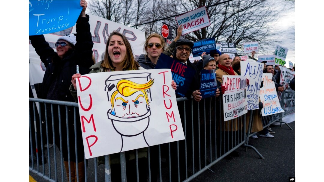 People protest near the site of a campaign appearance by Republican presidential candidate Donald Trump in Bethpage, New York, April 6, 2016.