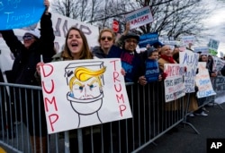 People protest near the site of a campaign appearance by Republican presidential candidate Donald Trump in Bethpage, New York, April 6, 2016.