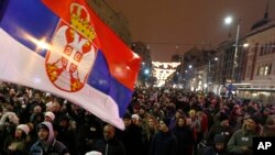 People march during a protest against populist President Aleksandar Vucic in Belgrade, Serbia, Jan. 12, 2019. Critics accuse the president of imposing an autocracy through strict control over the media and promoting hate speech against opponents.