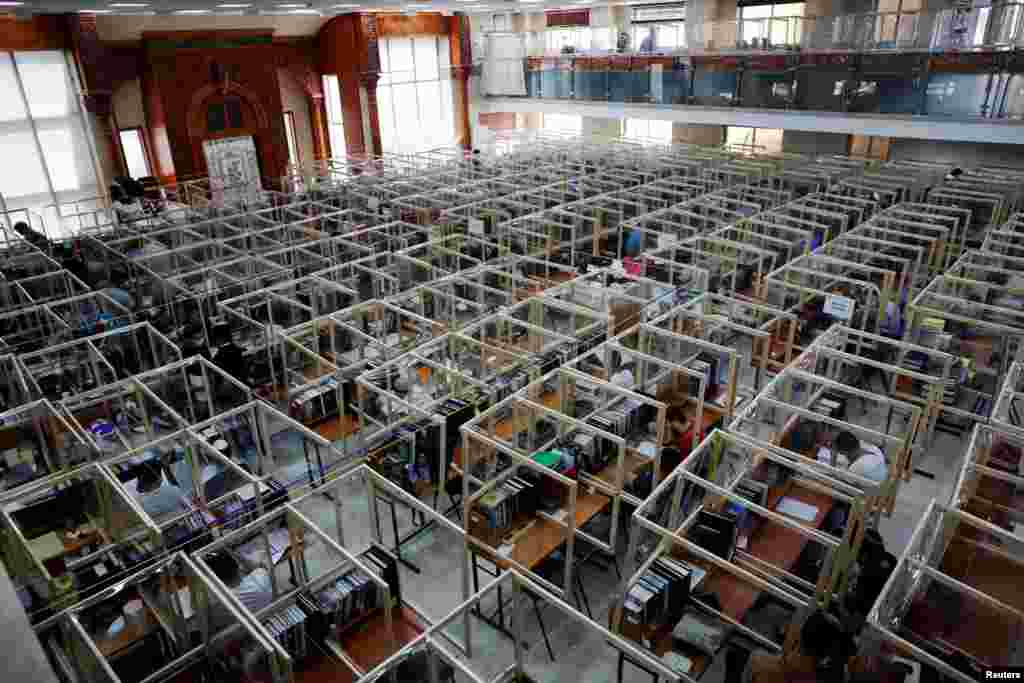 Jewish seminary students study at desks fitted with plastic sheets to protect them from the spread of the coronavirus disease in Sderot, Israel.