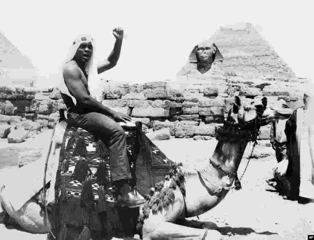 World heavyweight boxing champion Muhammad Ali visited the pyramids area, rode a horse and a camel and shook hands with the Bedouins who guard the huge monuments there, May 30, 1966.