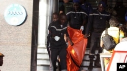 A body is removed from the Radisson Blu hotel, after it was stormed by gunmen during a attack on the hotel in Bamako, Mali, Friday, Nov. 20, 2015. Islamic extremists armed with guns and grenades stormed the luxury Radisson Blu hotel in Mali's capital Friday morning, and security forces worked to free guests floor by floor. (AP/Harouna Traore)