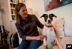Jessica Wright sits next to her dog Penny at their home in Decatur, Georgia on April 6, 2021.  Wright had to make distant vet appointments when she took Penny home during the coronavirus pandemic.