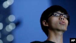 Joshua Wong, 17-year old student leader, stands on the stage during a rally in the occupied areas at Central district in Hong Kong, Oct. 9, 2014.
