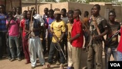 Members of a civilian defense group in Makary, Cameroon, arm themselves with bows and arrows. Authorities say such groups get support from soldiers in Cameroon’s Rapid Intervention Brigade. (M.E. Kindzeka/VOA)